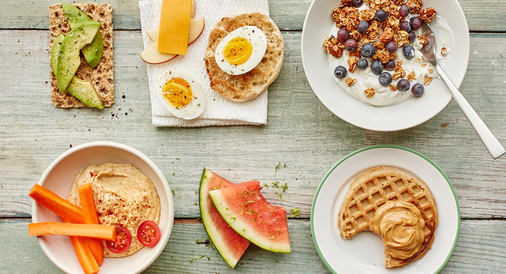healthy snack options - avocado on cracker, eggs, yohurt, hummus and waffle with peanut butter