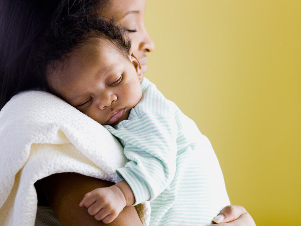 mother holding a sleeping baby