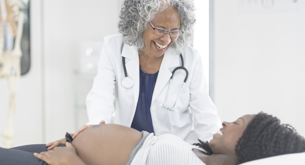 pregnant woman being examined by physician