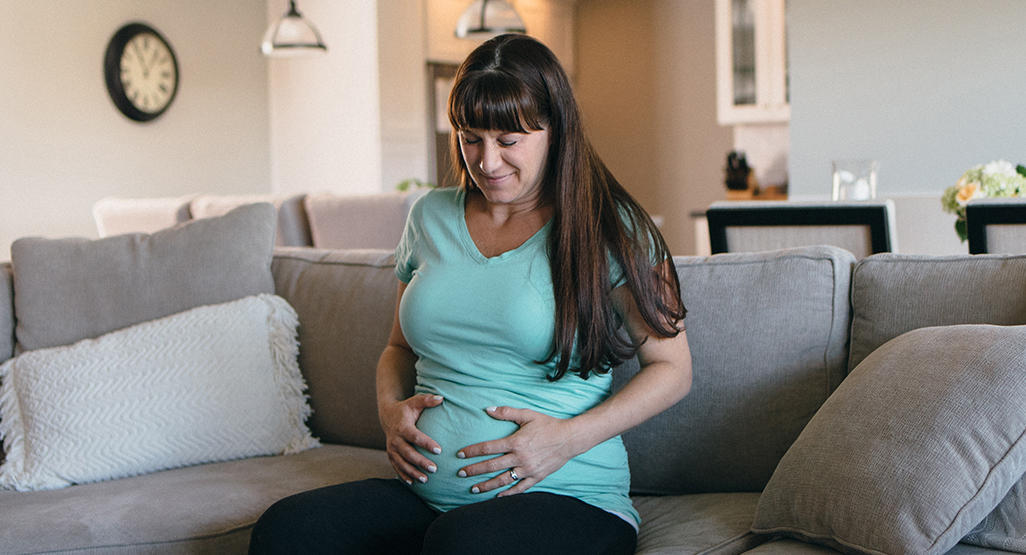pregnant woman in pain, holding her belly