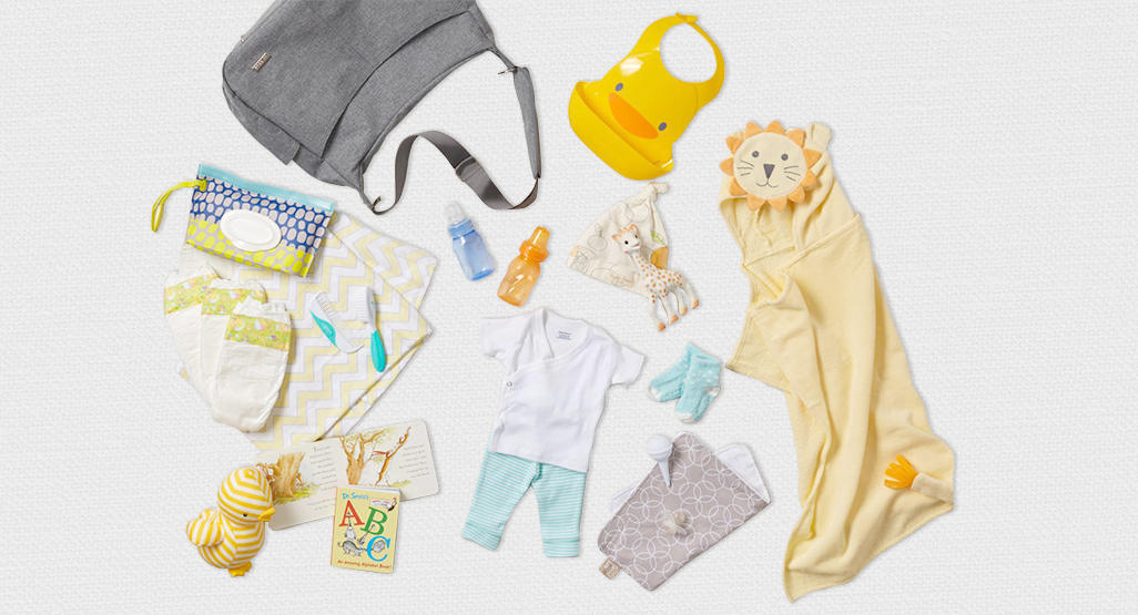 assorted baby items spread out across a blanket
