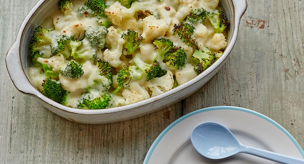 broccoli and cauliflower topped with cheese in baking dish