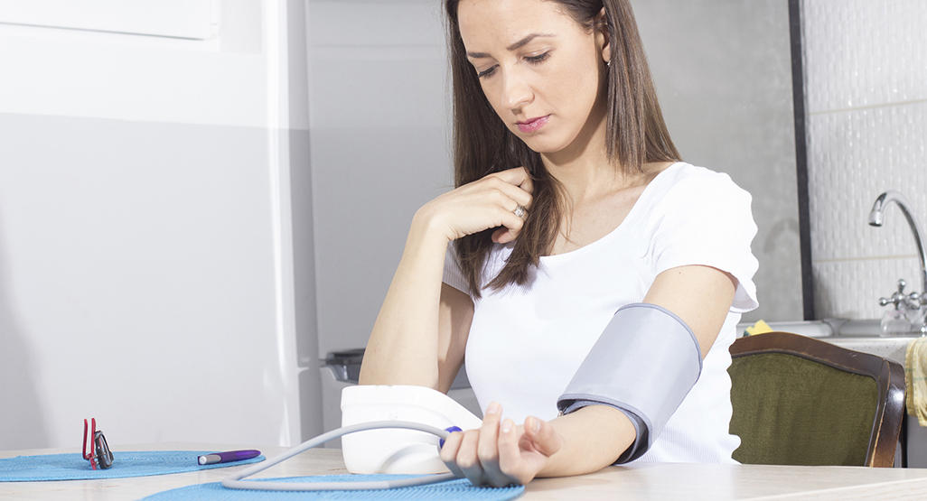 woman measuring her blood pressure