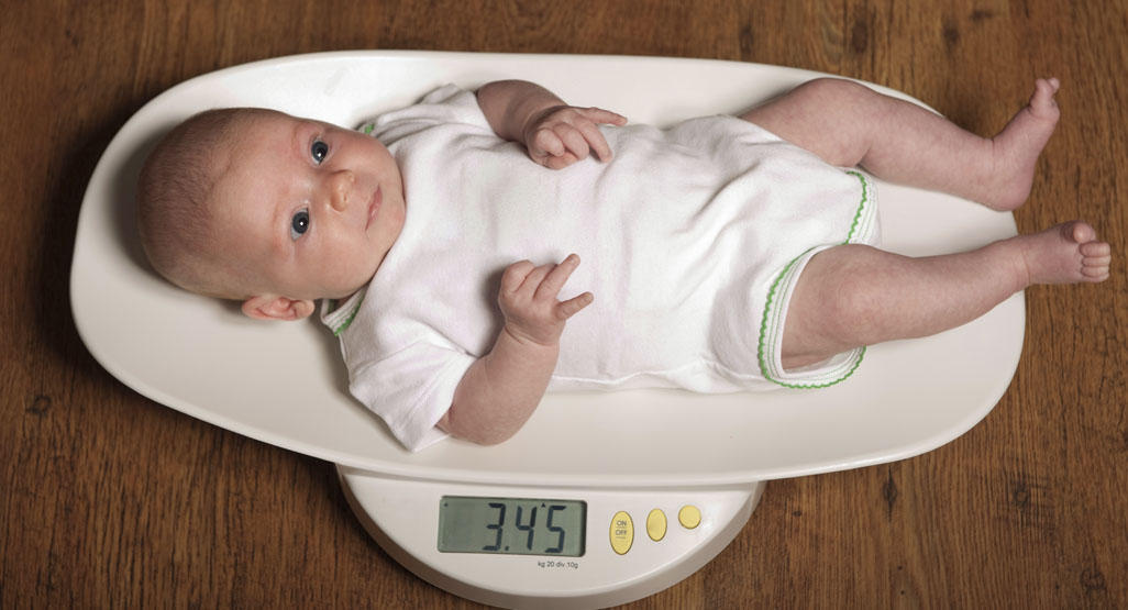 baby laying on a digital scale