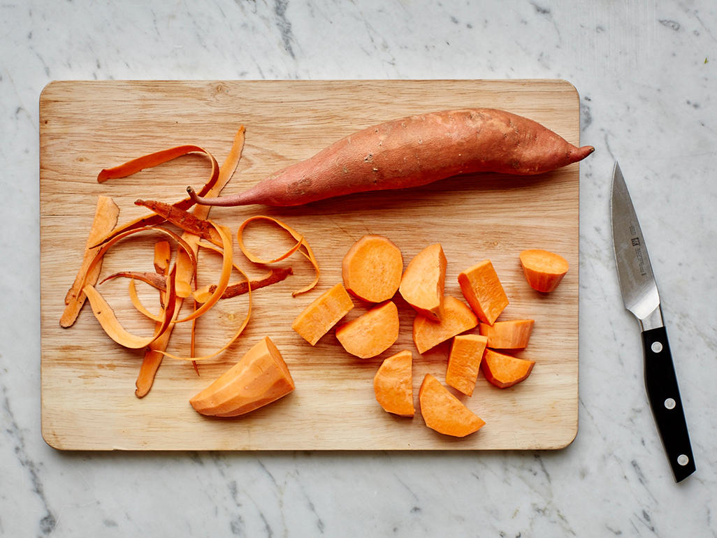 sweet potato on wooden cutting board