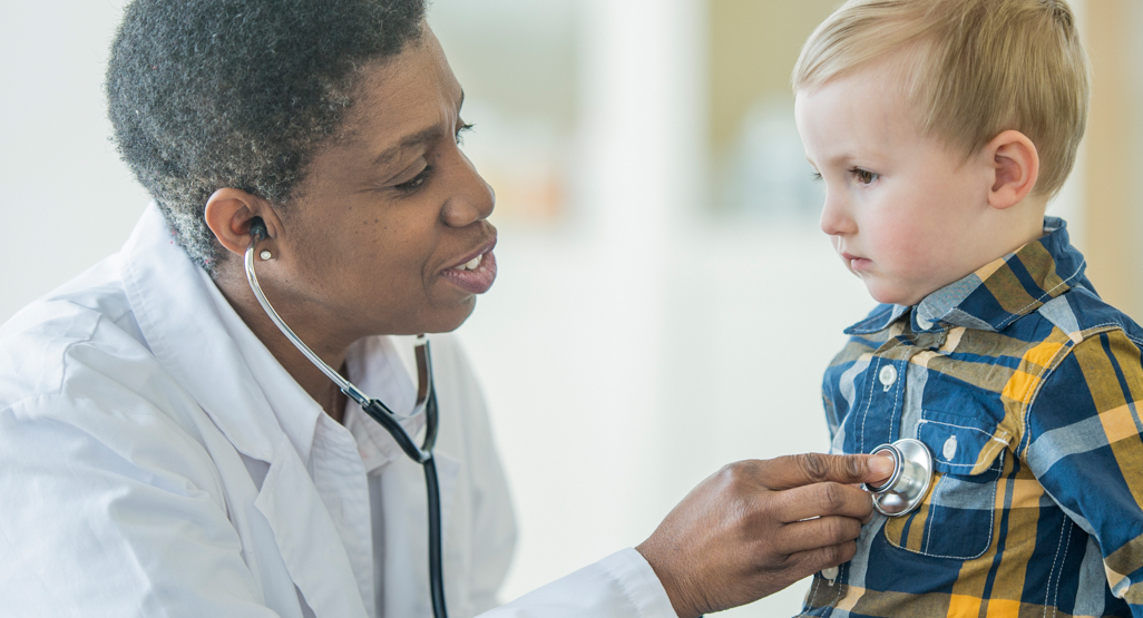 physician listening to little boys heart with stethoscope