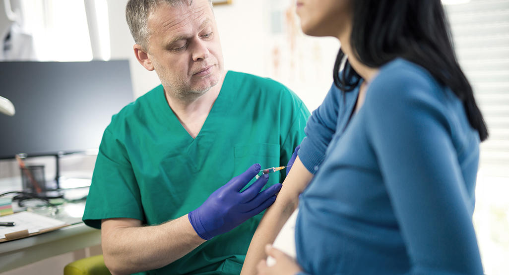 pregnant woman getting a vaccine