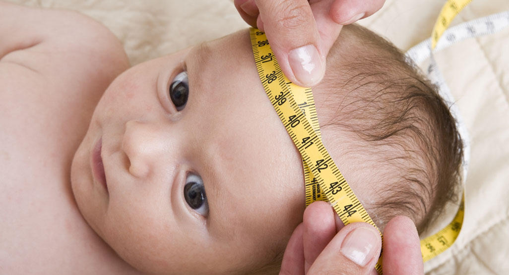 baby's head measured with a tape measure