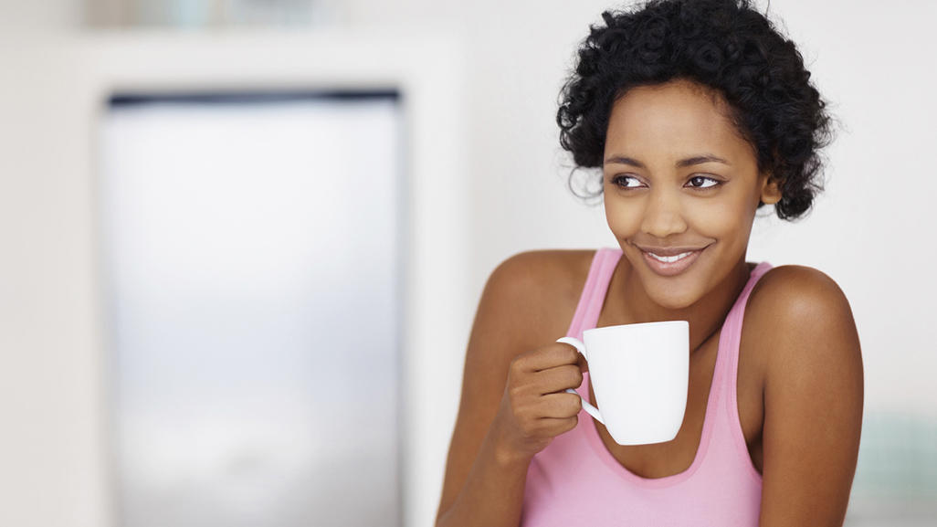 woman holding a coffee or tea mug