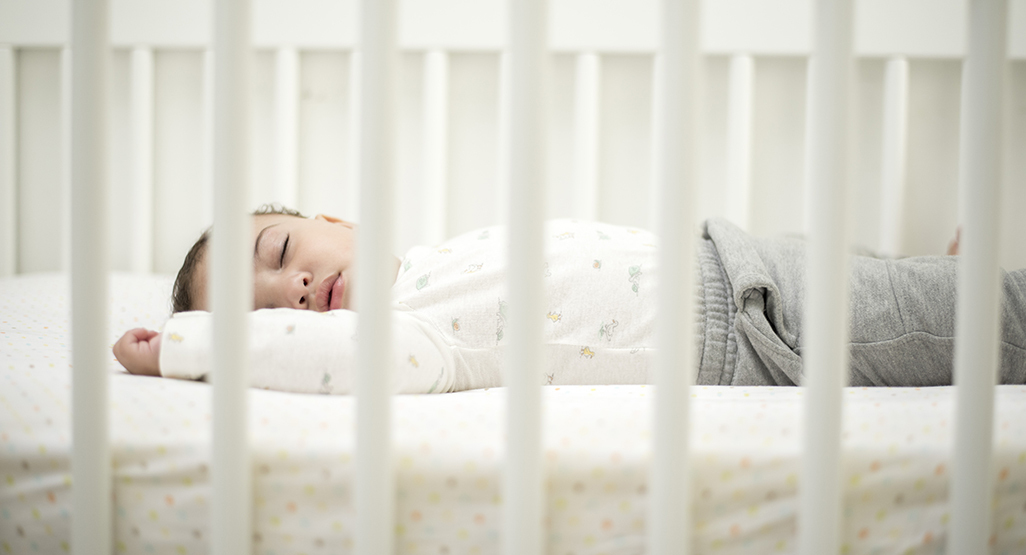 Toddler sleeping in a crib