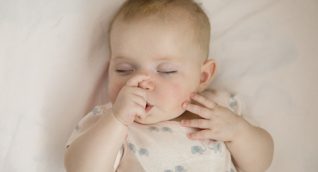 Baby sucking her finger while sleeping