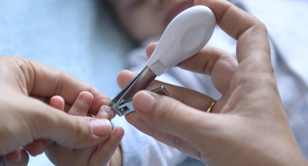 using a nail clipper to trim a baby's nails