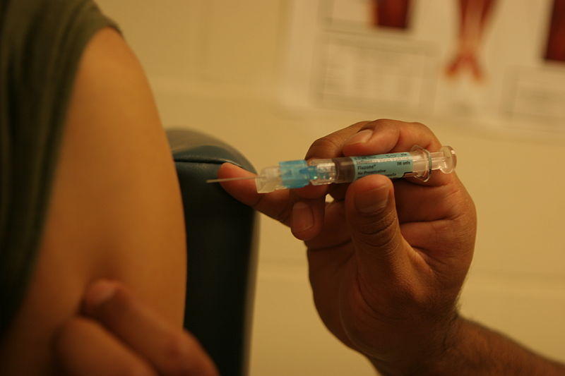 receiving a vaccine shot in the shoulder
