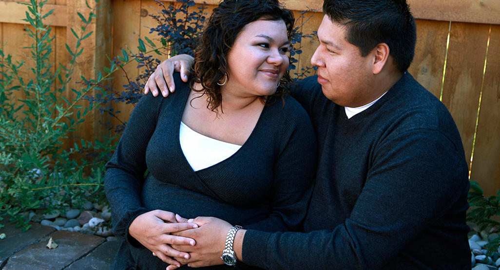 pregnant plus-size woman with her husband