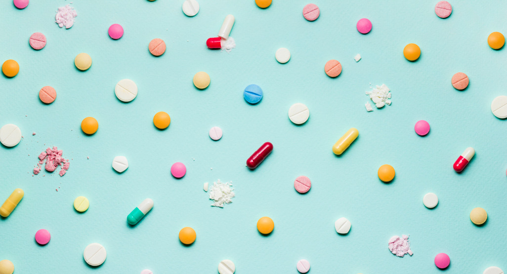 different colorful pills and tablets laid out on surface