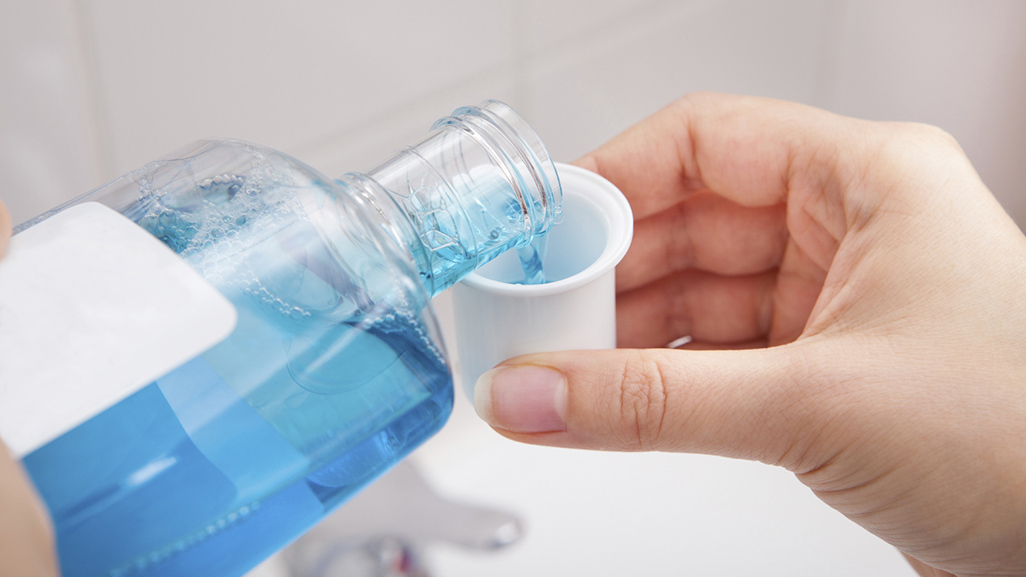 blue liquid pouring into small cup