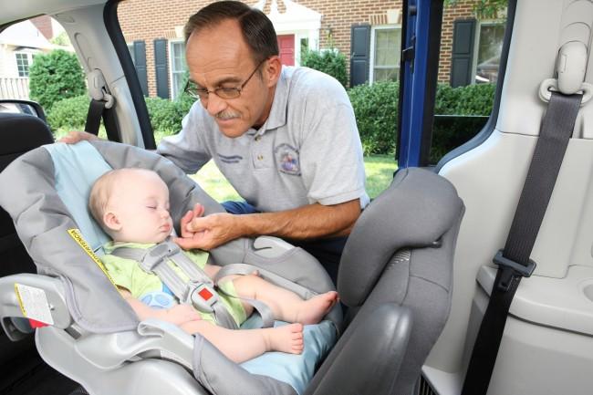 A professional car seat technician; image courtesy the NHTSA Images Library
