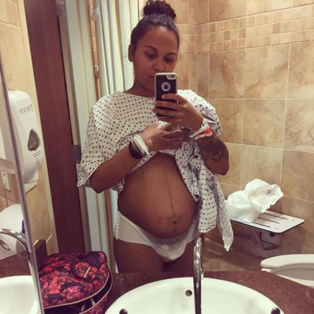 pregnant woman standing in a bathroom