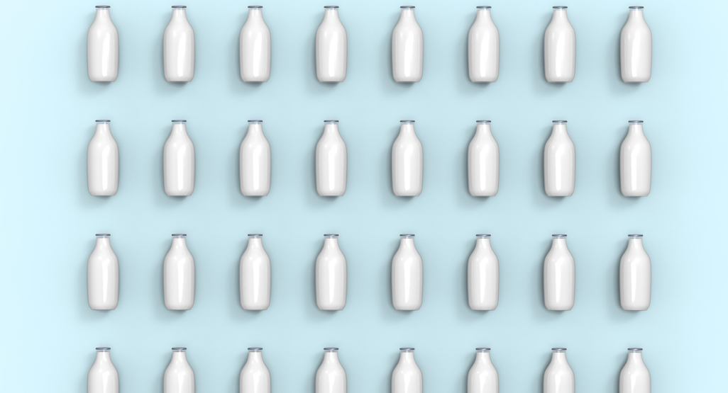 milk bottles laid out in straight lines on surface