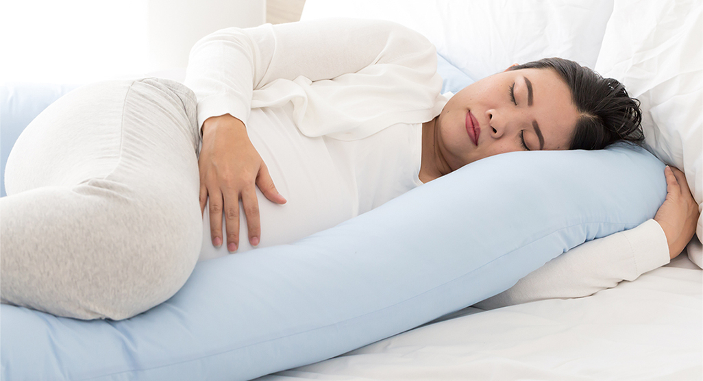 pregnant woman sleeping in the bed