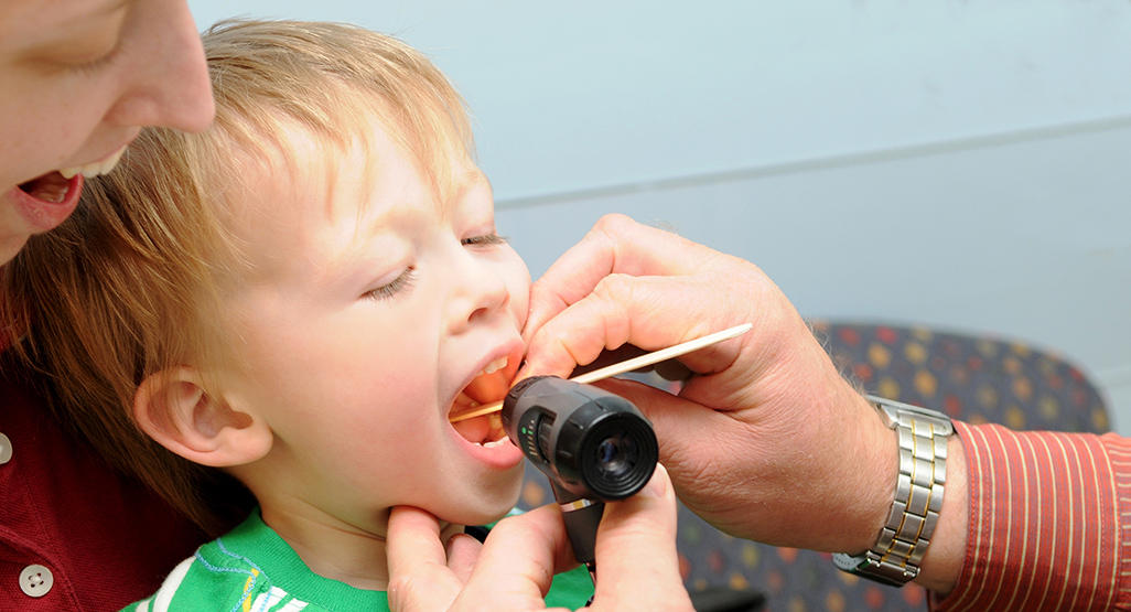toddler getting his throat examined