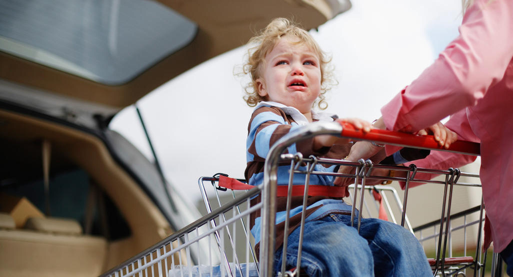crying baby in a shopping kart