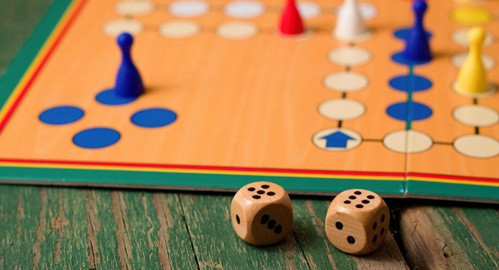 wooden dices next to a board game
