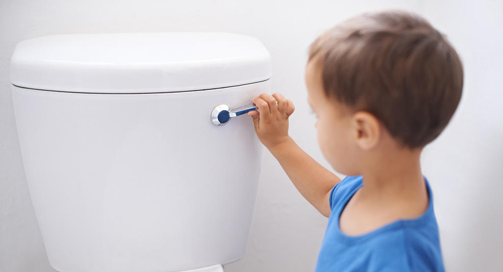 child flushing the toilet