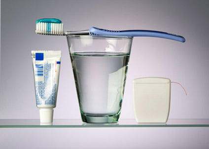 toothbrush, toothpaste and a glass of water