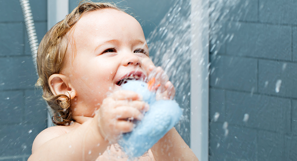 Child smiling in shower