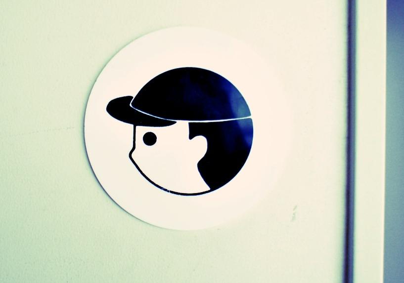 a badge with illustration of a boy wearing a hat