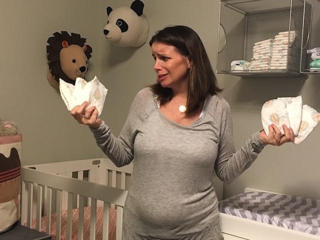 woman holding several diapers in both hands