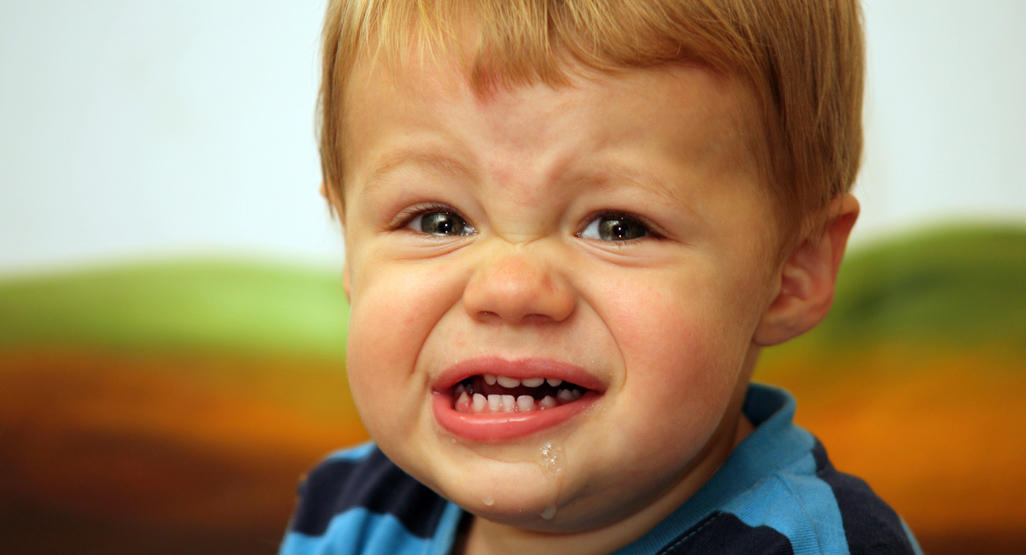 boy crying and driveling with mouth open